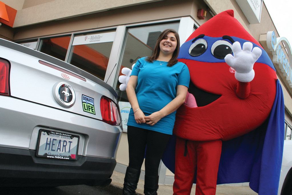 Allison Lindgren poses with Hemoglobin, the RI Blood Center mascot.