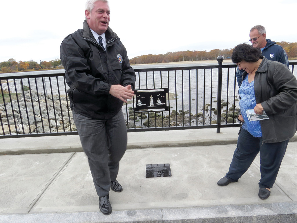 OFFICIAL NAMING: Mayor Scott Avedisian has a laugh after revealing a stone plaque on the sidewalk of the newly restored bridge, which reads “Danger Bridge 2013,” along with the city’s seal. City Council President Donna Travis fought furiously to convince Avedisian that was indeed the name of the bridge as she campaigned for its restoration.