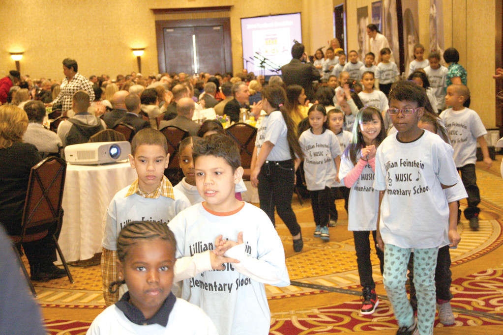 KIDS’ TOUCH: A junior chorus of first- and second-graders from the Lillian Feinstein/Sackett Street School leave the grand ballroom at the Crowne Plaza after performing two songs at Monday’s release of the 2014 KIDS COUNT Factbook.