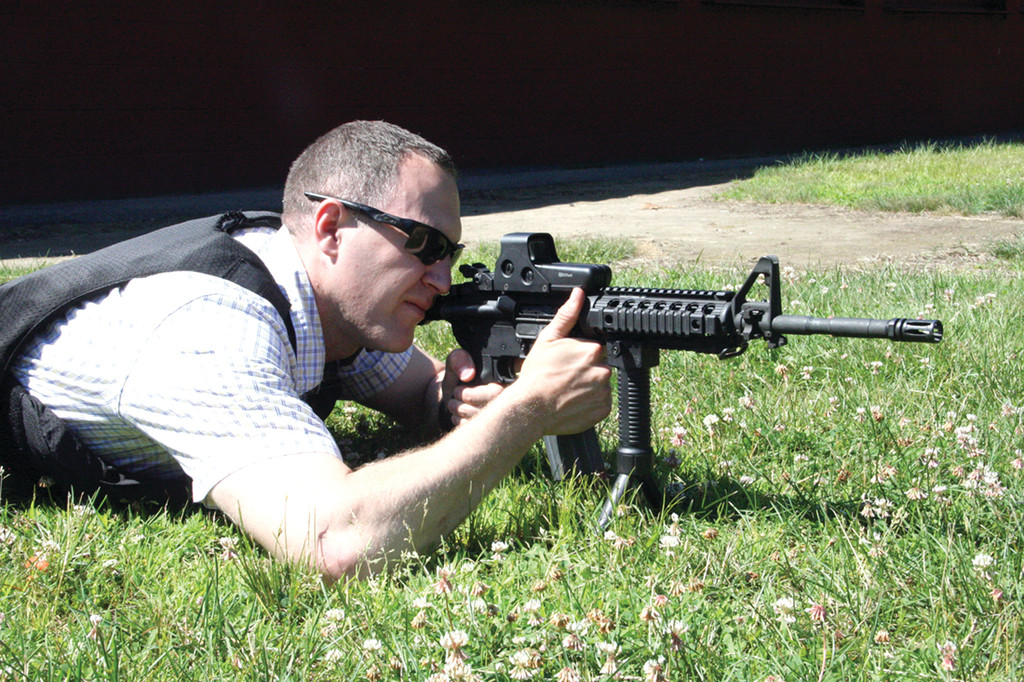MAKING ADJUSTMENTS: Detective Brent Groeneveld zeros in his rifle’s scope to improve its accuracy at different distances from the target.