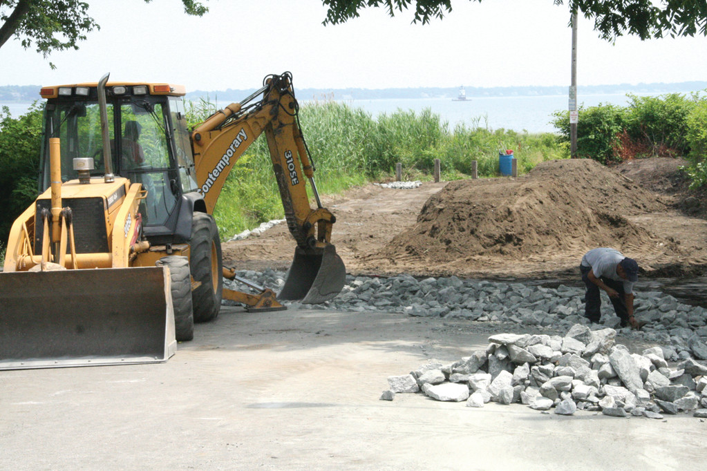 END OF THE ROAD: About 90 feet of pavement has been removed from Mill Cove Road where it ends at Narragansett Bay. In its place crews are installing a stormwater drainage system aimed at reducing erosion as well as plantings designed to protect the area from storms.