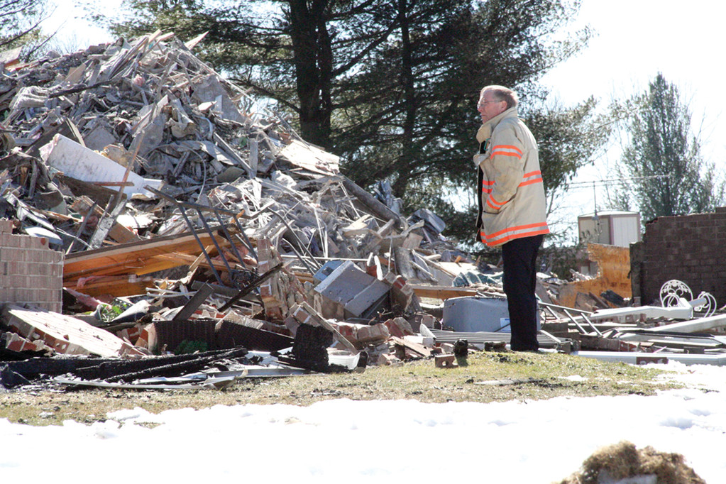 THE DAY AFTER: THE DAY AFTER: Fire Chief Edmund Armstrong looks over the pile of rubble remaining after fire consumed Building C of the Westgate Condos.