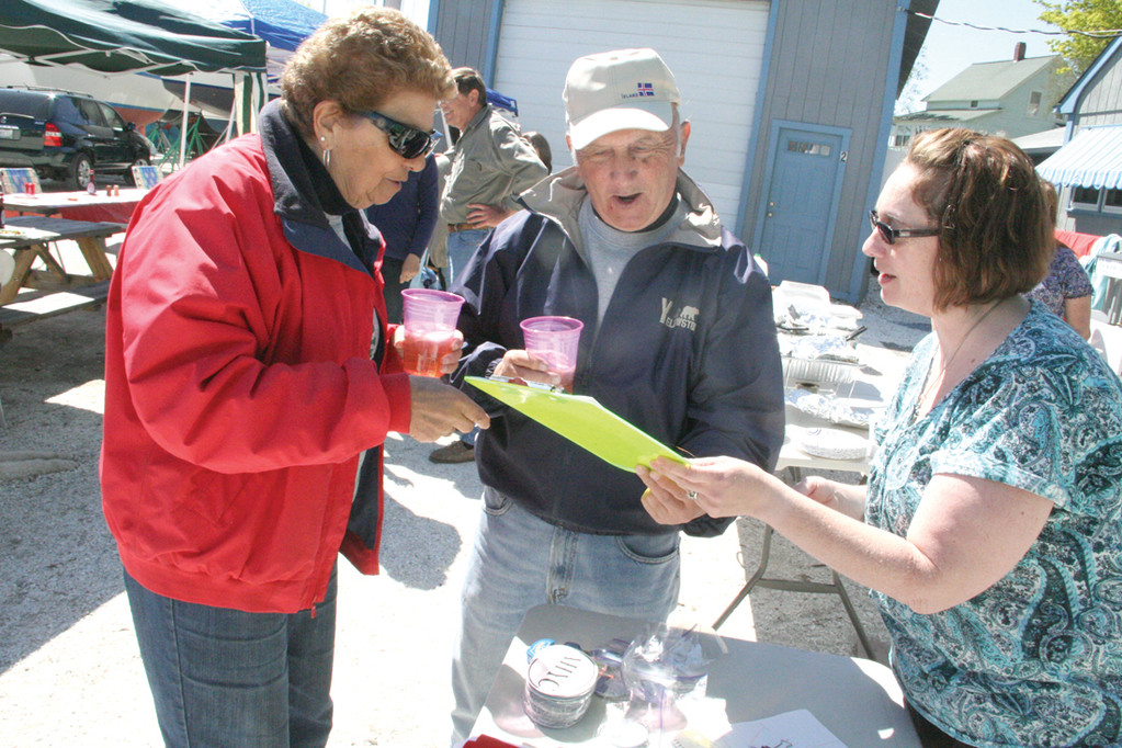 CATCHING UP: Apponaug Harbor Yacht Club Commodore Kim Interrante chats with members Jean DeCosta and Leo Andryc during the club’s annual fitting out breakfast Saturday.