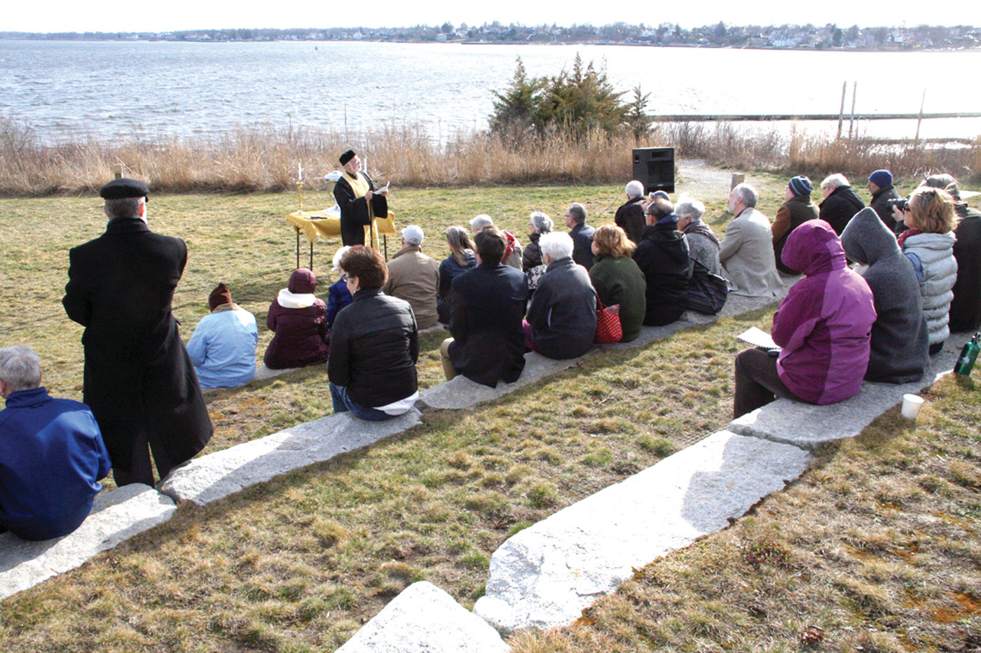 WATER, SOURCE OF LIFE: The Rev. Andrew G. George, pastor of the Church of the Annunciation Greek Orthodox Parish of Greater Providence, led a blessing of waters outside the Fields Point headquarters of Save The Bay Saturday afternoon.