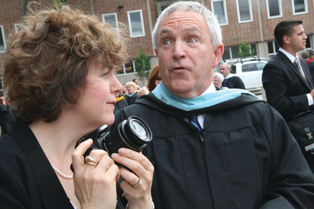TRYING TO SPOT HER SON: Lisa Mueller searches the graduating seniors for her son Stephen Jr. as they assemble outside the cathedral in preparation for commencement. With a startled look beside her is school Principal Joseph “Jay” Brennan.