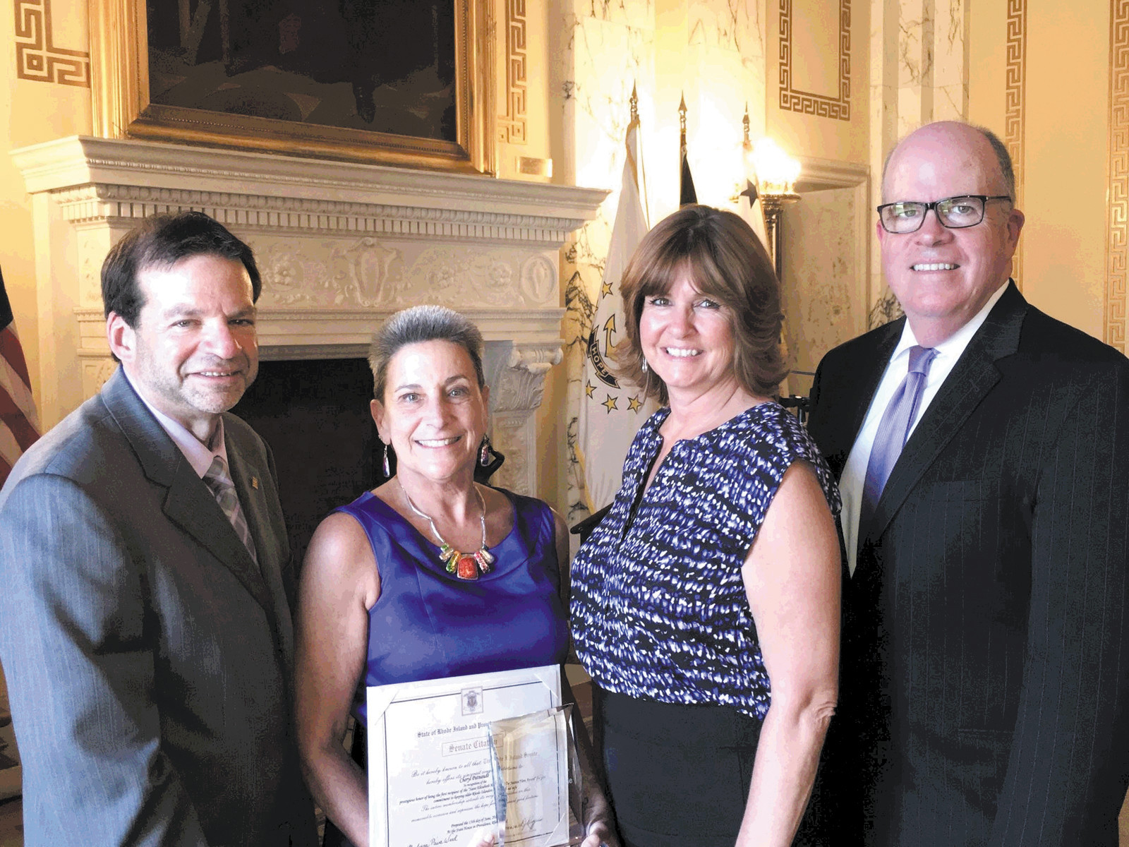 ELDER JUSTICE HERO: Cheryl Patnaude was awarded the Elder Justice Hero Award on Elder Abuse Awareness Day, June 15, at a ceremony at the State House. From left are Steve Horowitz, president and CEO Saint Elizabeth Community, Patnaude, Kathy Parker Director of admissions Saint Elizabeth Community and Charles Fogarty director of the division of elderly affairs.