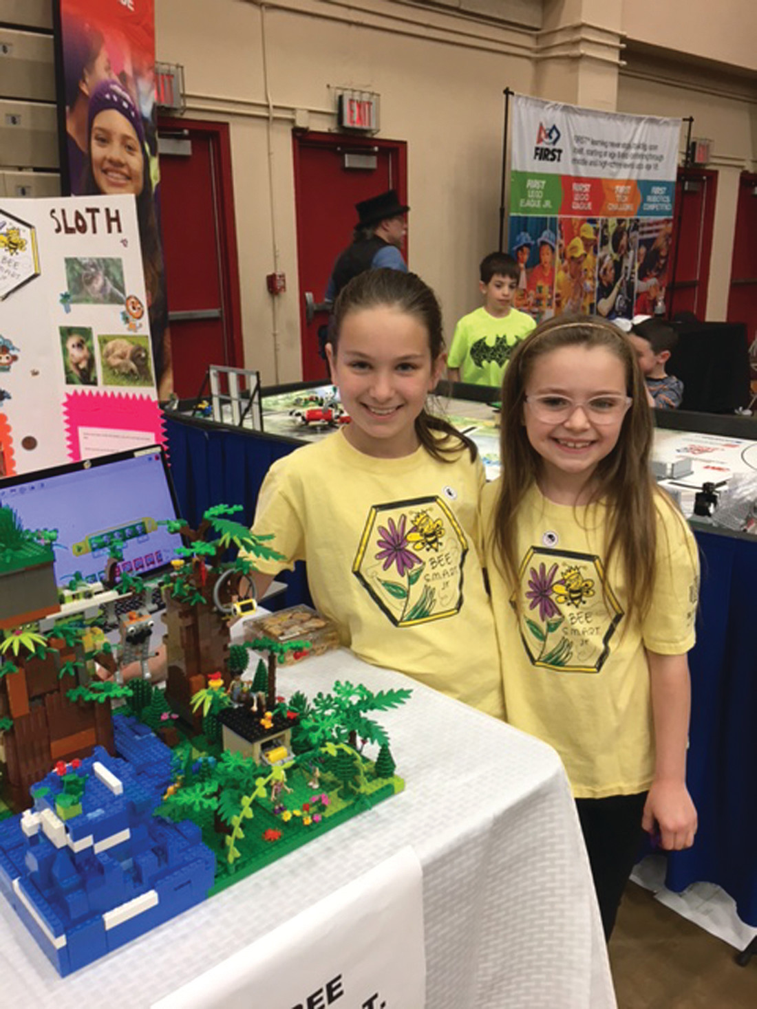THEIR CREATION: Third graders Madison Medeiros (left) and Aurora Christiansen proudly display their legs robotics project at Sunday’s Robot Block Party.