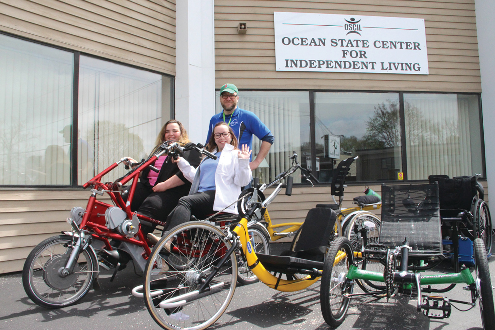 RIDING BY: Bike-On visited Ocean State Center for Independent Living in March with some of their adaptive hand cycles, recumbent trikes and special needs pediatric trikes. Pictured are Bike-On employees Dan Bizzle and Rachel Anderson as well as OSCIL’s Lunch and Learn Coordinator Heather Schey, at left.