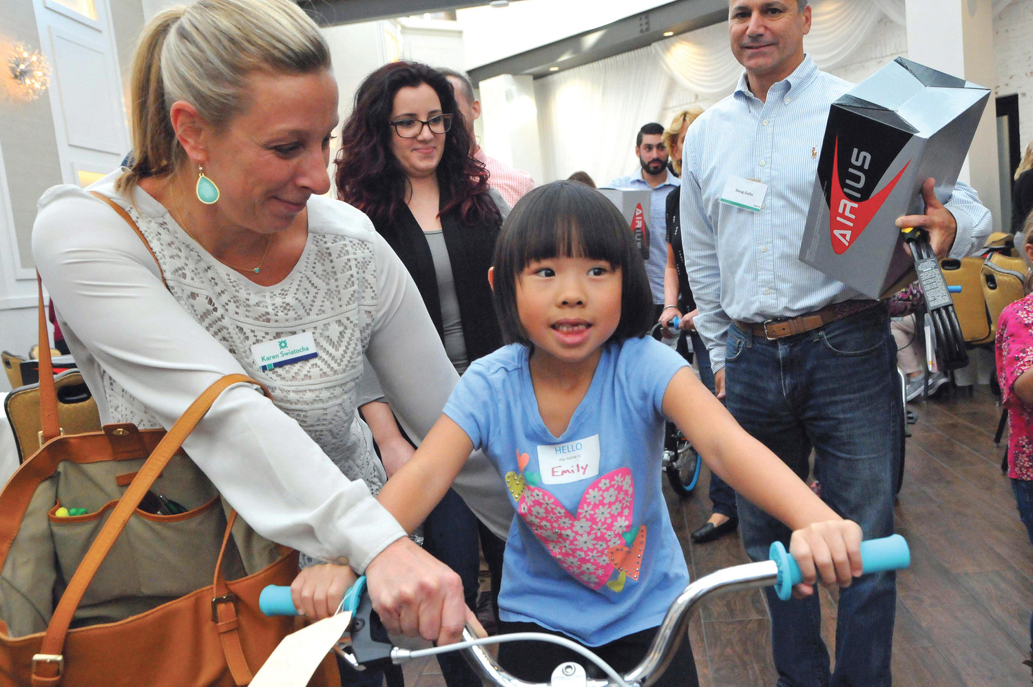 READY TO RIDE: Karen Swiatocha makes sure that first grade student Emily has her balance.