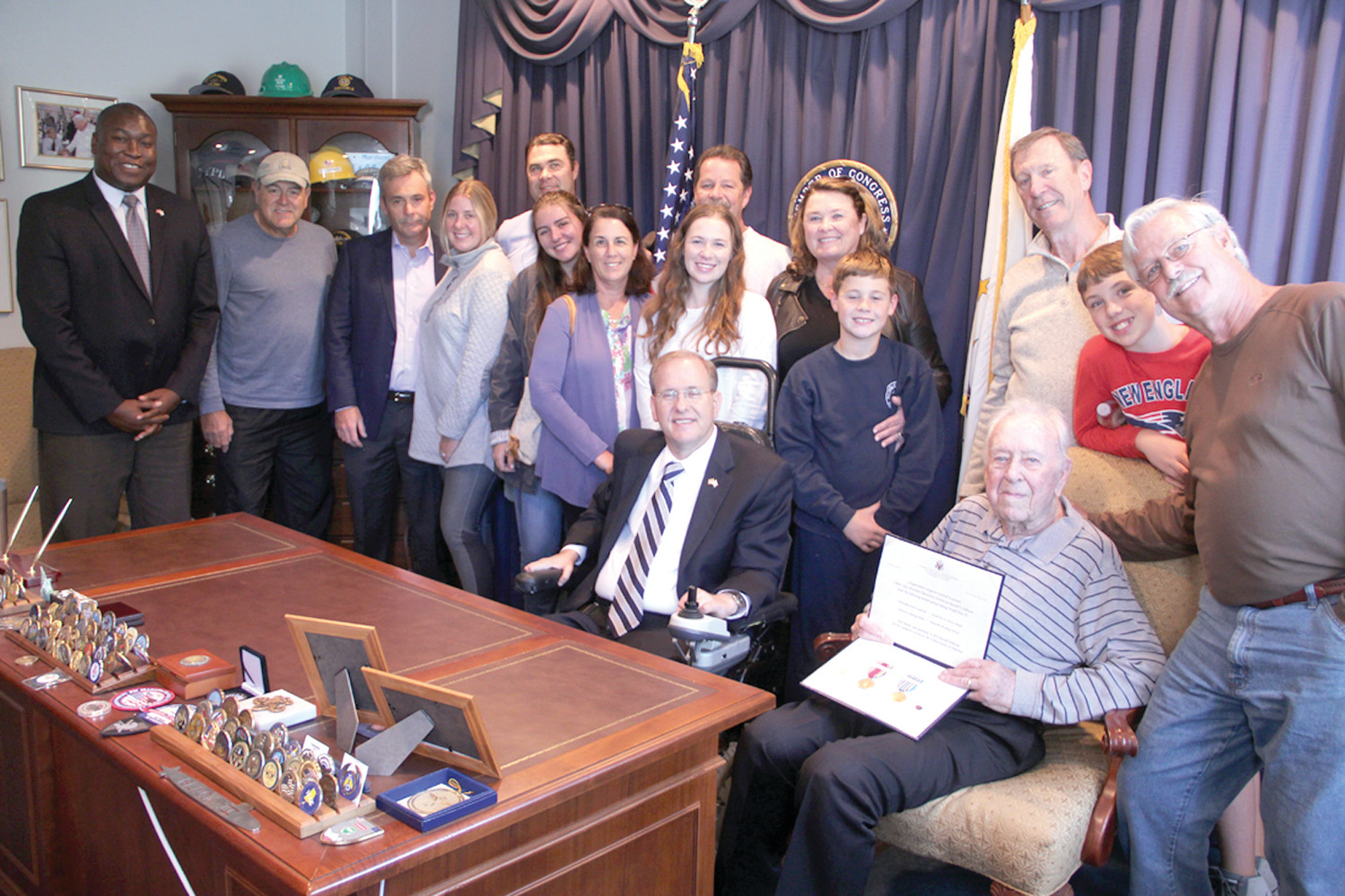 CELEBRATING HIS SERVICE: Congressman Jim Langevin presented WWII medals and awards to Russell Johnson at his office Tuesday. They were joined by members of Johnson’s extended family and Rhode Island Director of Veterans Affairs Kasim Yarn at far left.