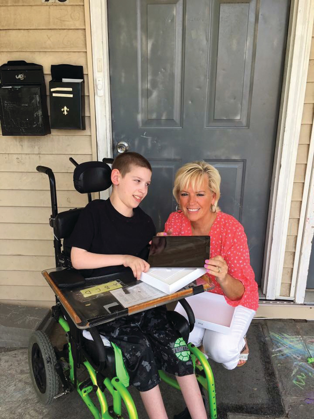 CLOUD-BASED ANGEL: Debbie Roffo with Jeremy, who has cerebral palsy and communicates with an iPad. When his iPad broke, his mother wondered how she would get the money to fix it. Roffo's angels stepped up and bought him a brand new one.