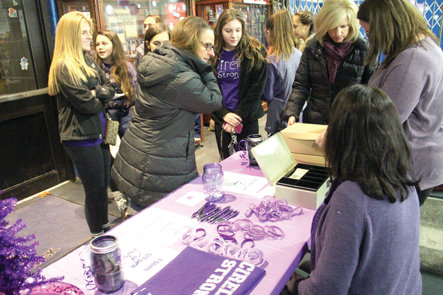 TO BENEFIT THE FOUNDATION: Friends of Tara Cirella and members of the Gianna Cirella Memorial Foundation decorated Thayer Arena in purple for Friday’s Toll Gate hockey games as well as sold t-shirts and purple bracelets in Gianna’s memory.
