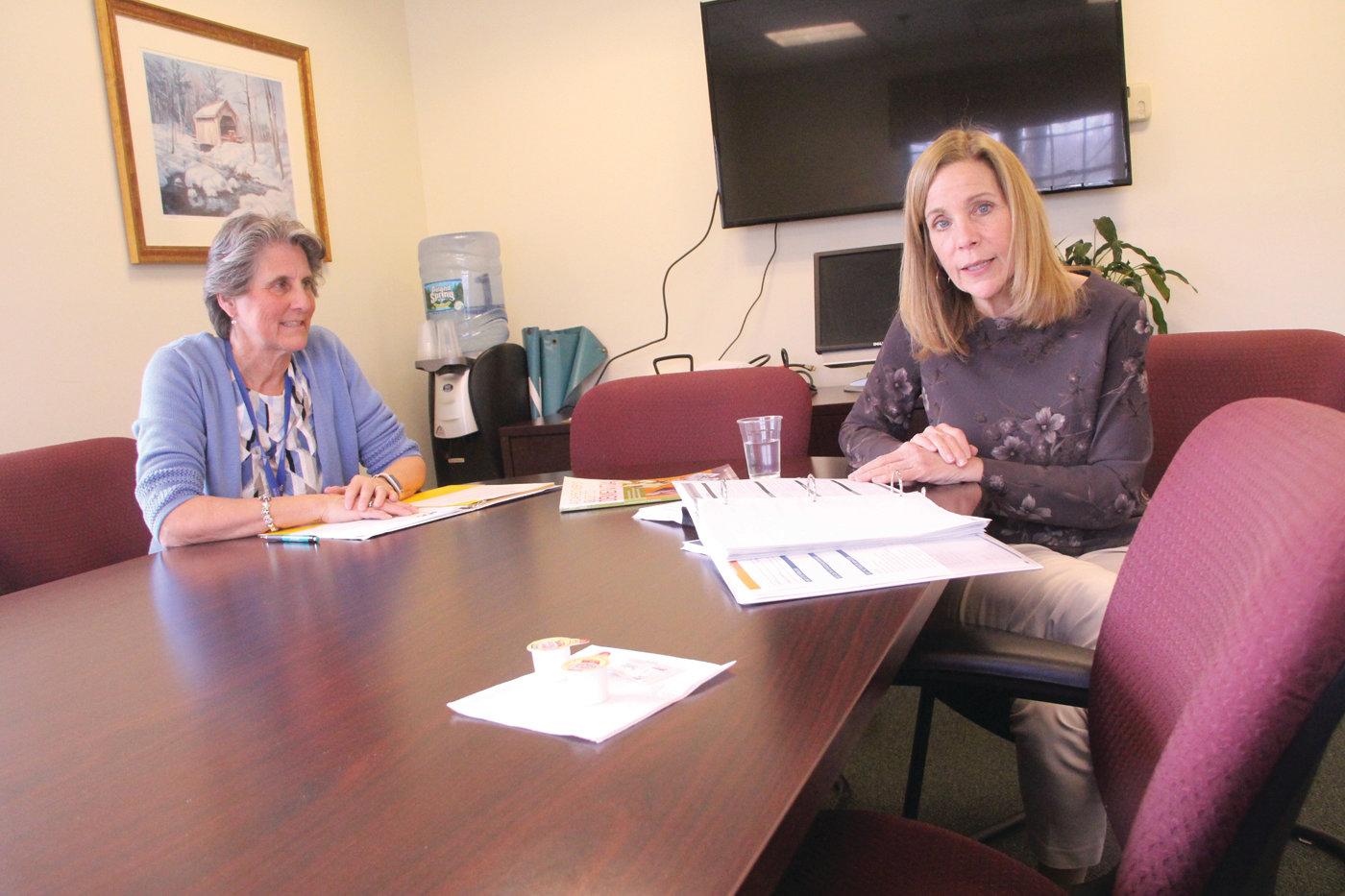 HELPING CAREGIVERS: Kim Morris and Dottie Santagata of Cornerstone Adult Services review procedures of the nationwide Improving Outcomes for Families and Older Adults: Adult Day Service Plus (ADS Plus) research study the center is participating in.