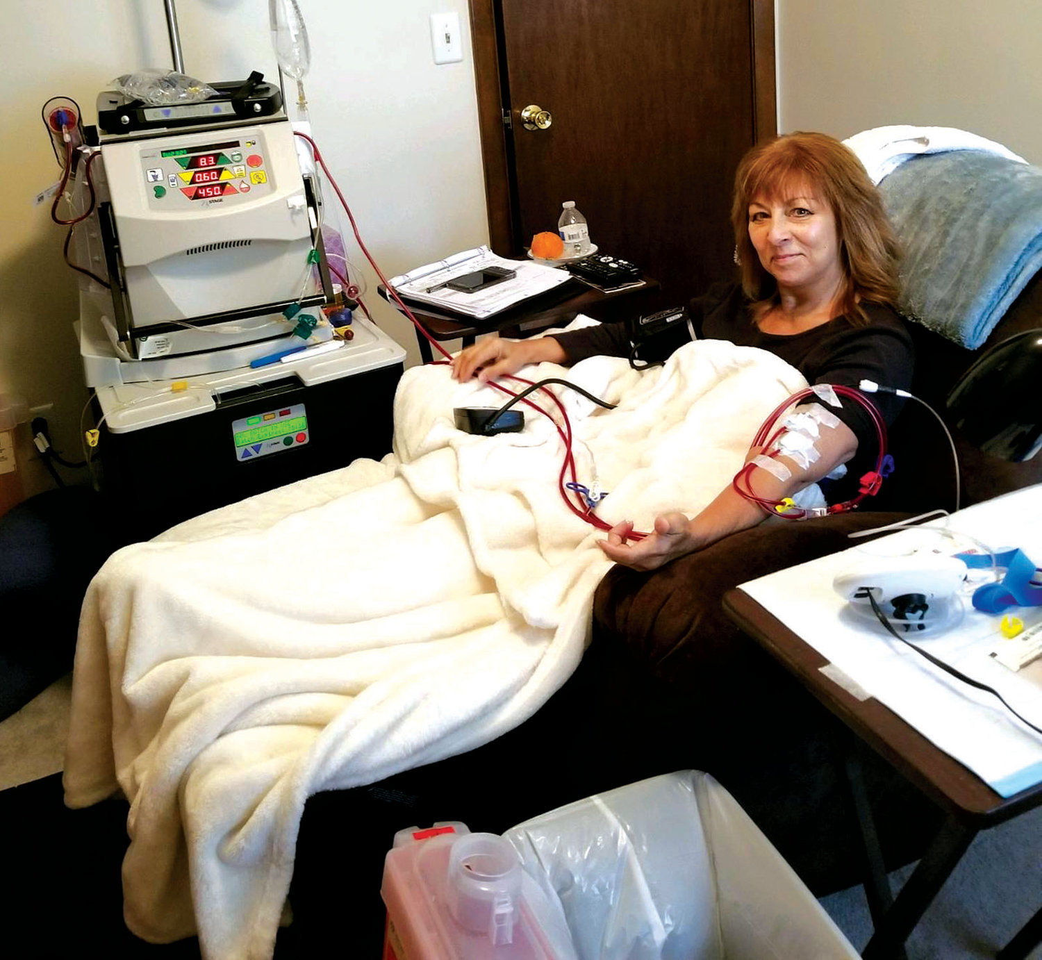 WINNING THE FIGHT: Warwick native and former body builder Sue Flesia undergoes dialysis treatment at her home using an NxStage machine.