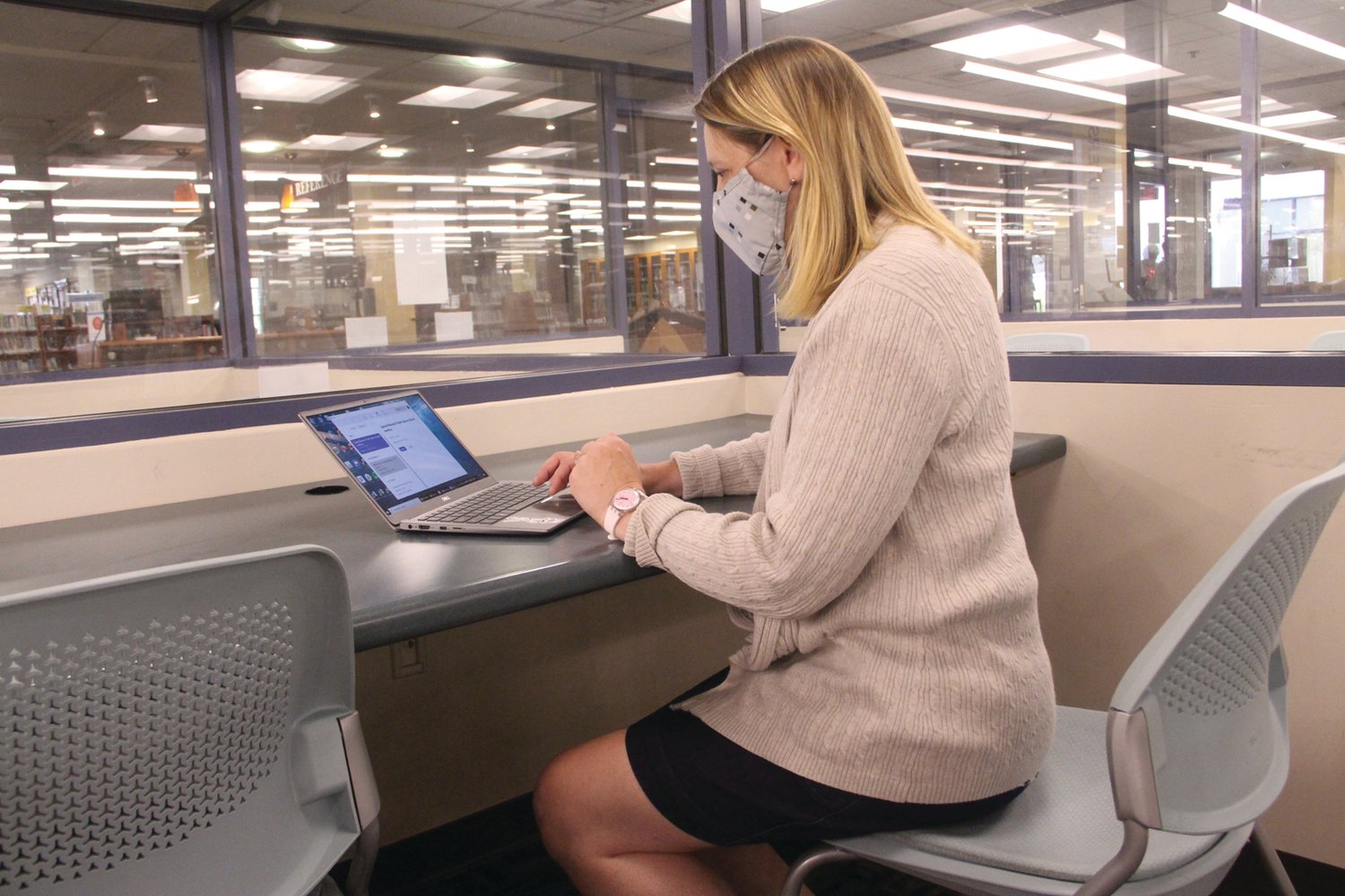 JOB HUNTING: Jana Stevenson, deputy director of the Warwick Public Library uses a laptop to illustrate how those looking for a job will be able to participate in the job fair from one of the glass rooms at the library.
