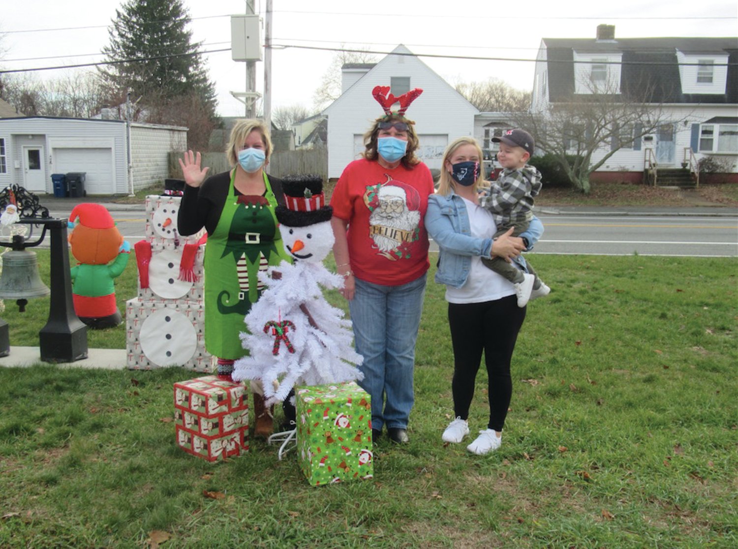 CONNOR’S CORNER: Tri-City Elks members Donna Beauregard, Danielle Grant and Exalted Ruler Deb Mangina are all smiles while making sure children like Connor enjoyed all the decorations and festivities of last weekend’s Drive-By to See Santa Claus in Warwick.
