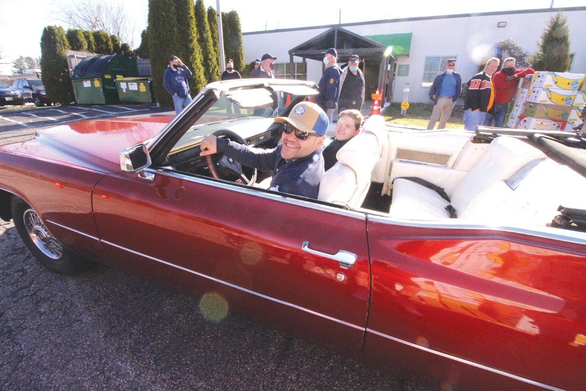 RIDING IN STYLE: John Faria saw an opportunity to drive his vintage 1970 Cadillac convertible Saturday. He brought along Blake Lopatka whose mother Sarah director of elderly and family services at Westbay Community Action and helped organize Saturday’s event.