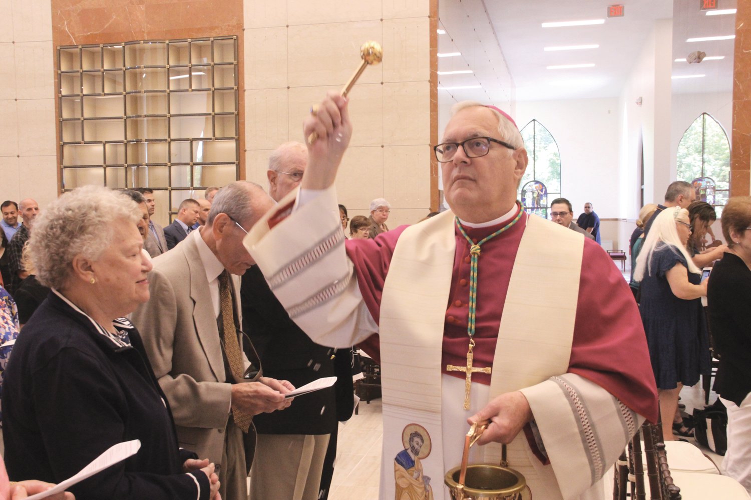 BLESSING: Following his homily, Roman Catholic Bishop Thomas J. Tobin blessed the mausoleum, sprinkling holy water throughout the chapel and corridors.