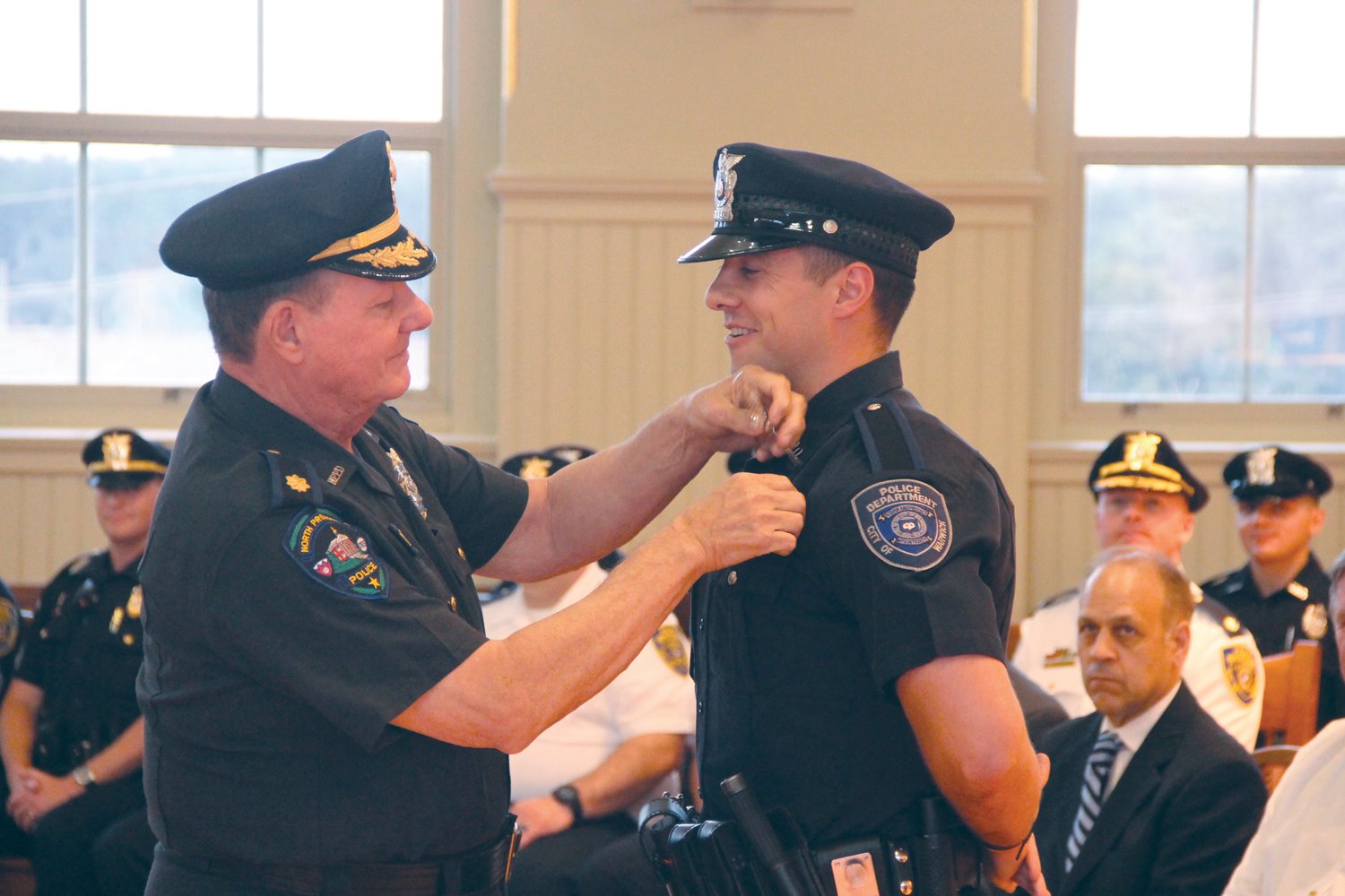 FOLLOWING HIS STEPS: Officer Nicholas DeLuca is pinned by his Father, Major William Deluca who has retired from the North Providence Police Department.