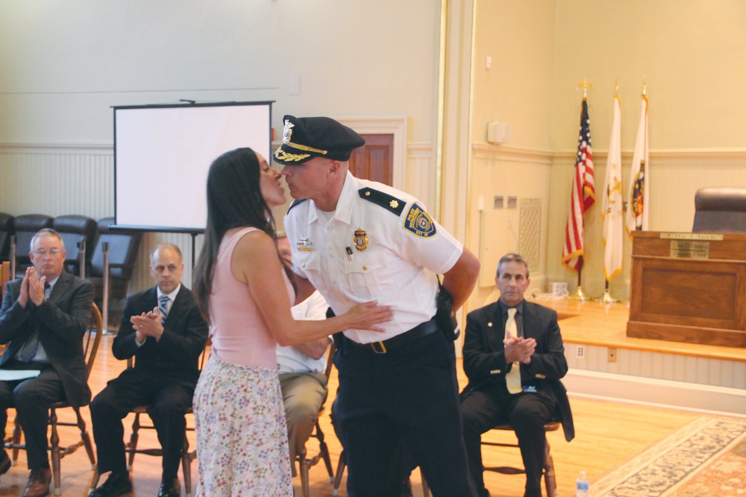 PINNED AND A KISS: Mary Sullivan kisses her husband Major Andrew Sullivan after affixing his badge.