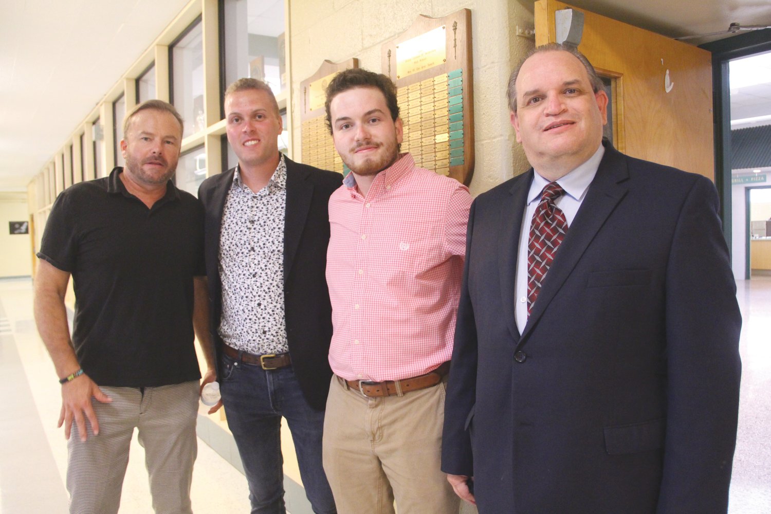 A LEGACY THAT LIVES ON:  Paul Bayne’s positive outlook on life and dedication to helping others was shared on Saturday at the world premiere of “Living With the Odds.” From left are Eric Meltvedt, Ryan Bayne, Luke Bayne, and Paul’s brother Richard.