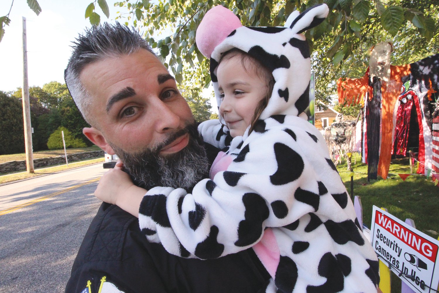 A COW GIRL:  Danny Hall with his daughter Cora outside his Halloween carnival display on Warwick Neck Avenue.