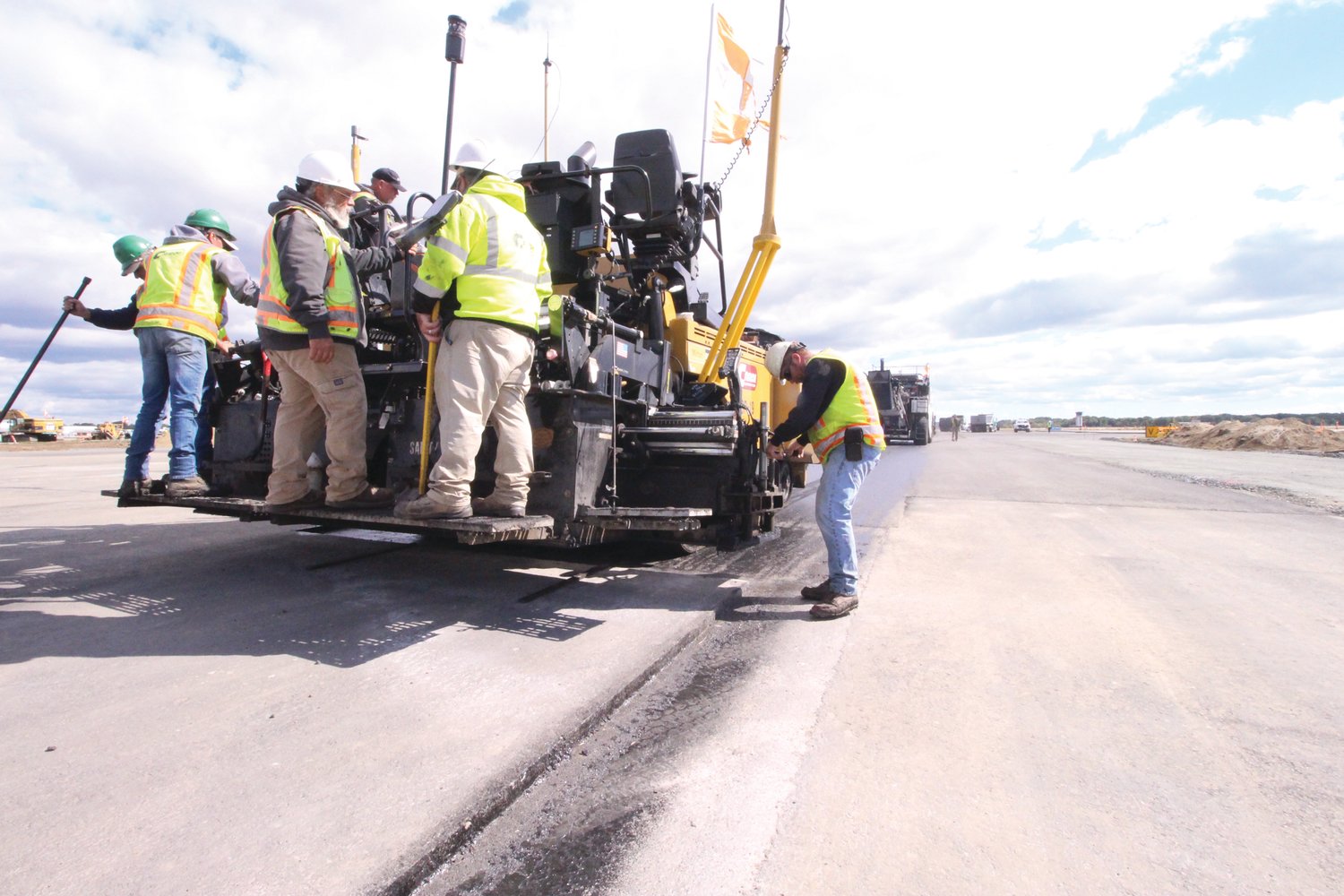 READY FOR ANOTHER LAYER: The Cardi Construction crew prepares to add another layer of asphalt to the crosswind runway.