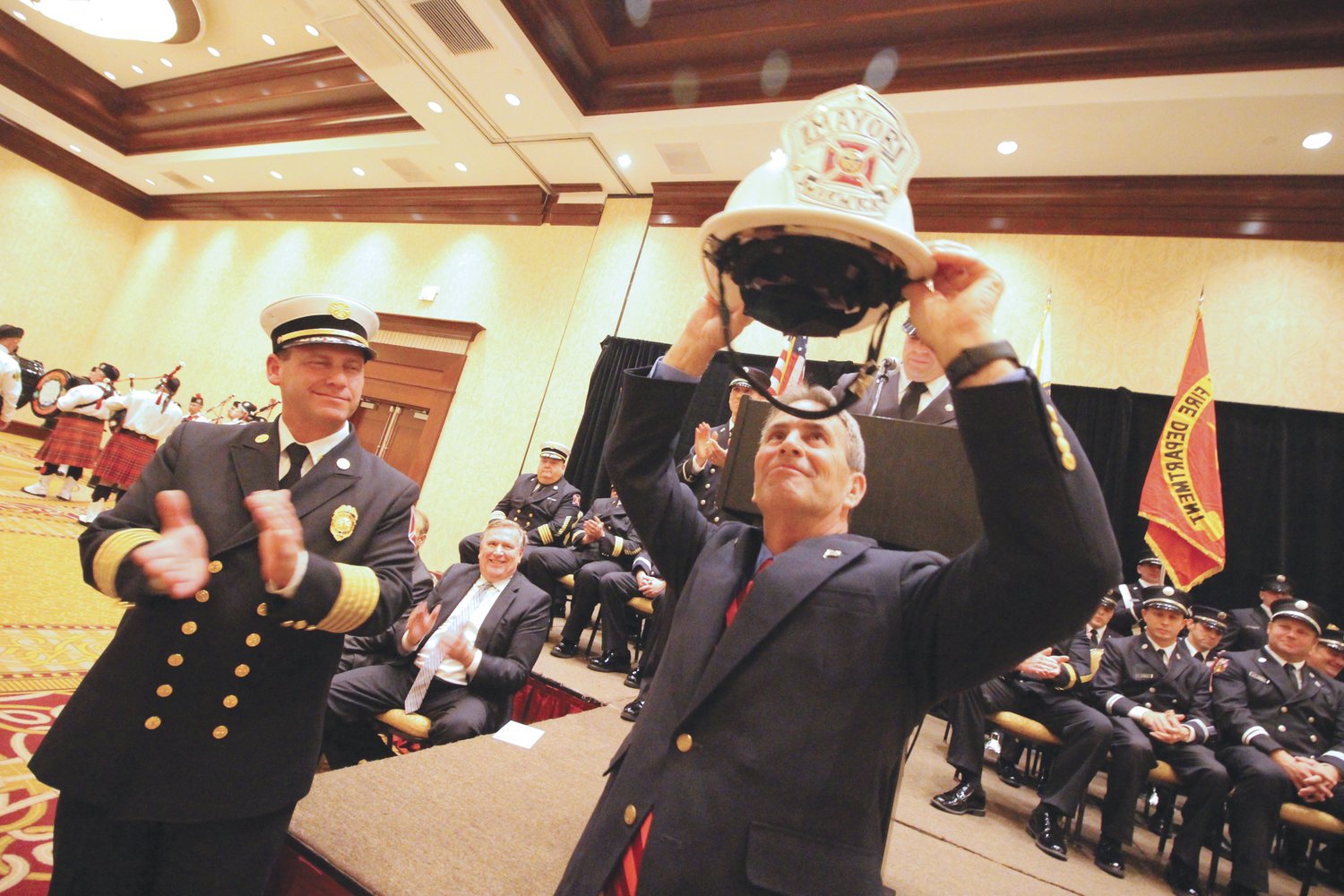 NOW THAT’S A HAT: Mayor Frank Picozzi takes a close look at the helmet he was presented by Lt. Michael Carreiro, president of Warwick Firefighters Local 2748