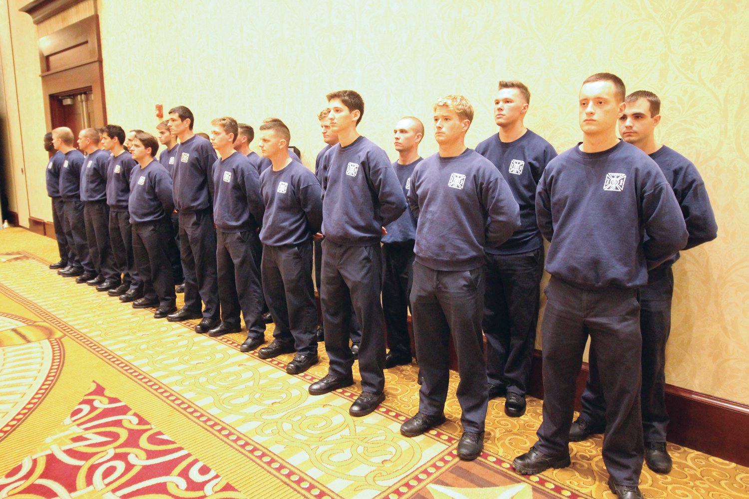 SILENT OBSERVERS: The class of fire recruits currently undergoing training stood at parade rest for the duration of the ceremony.