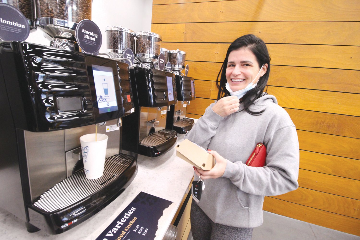 ONE OF THE FIRST: Desiree DelGrosso was one of the first, if not the first customer at the Neon Marketplace that
opened yesterday morning at the intersection of Airport and Post Roads.