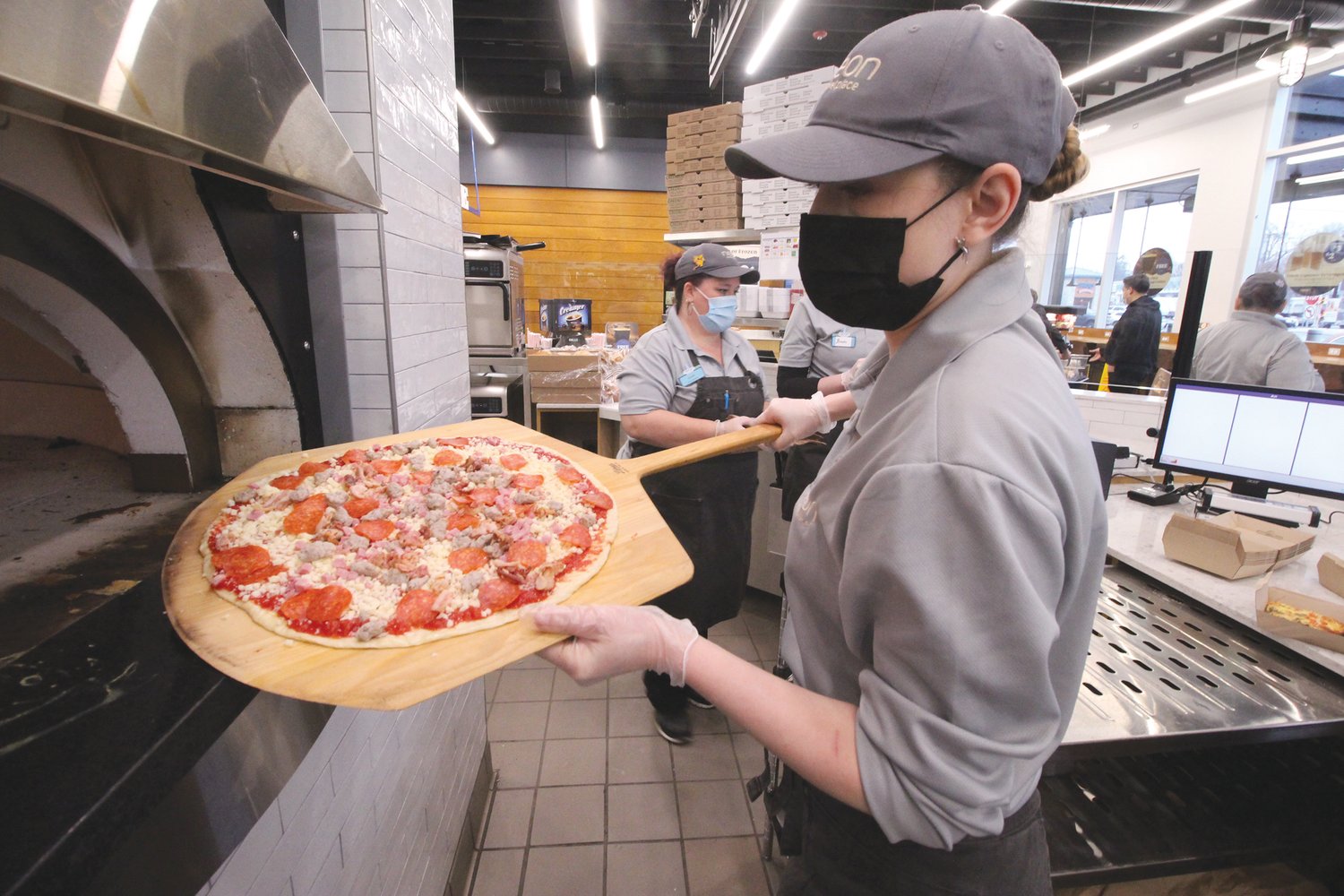 PIZZA PIE: Elsie Babie puts the finishing touches on a freshly-made pizza at Neon.