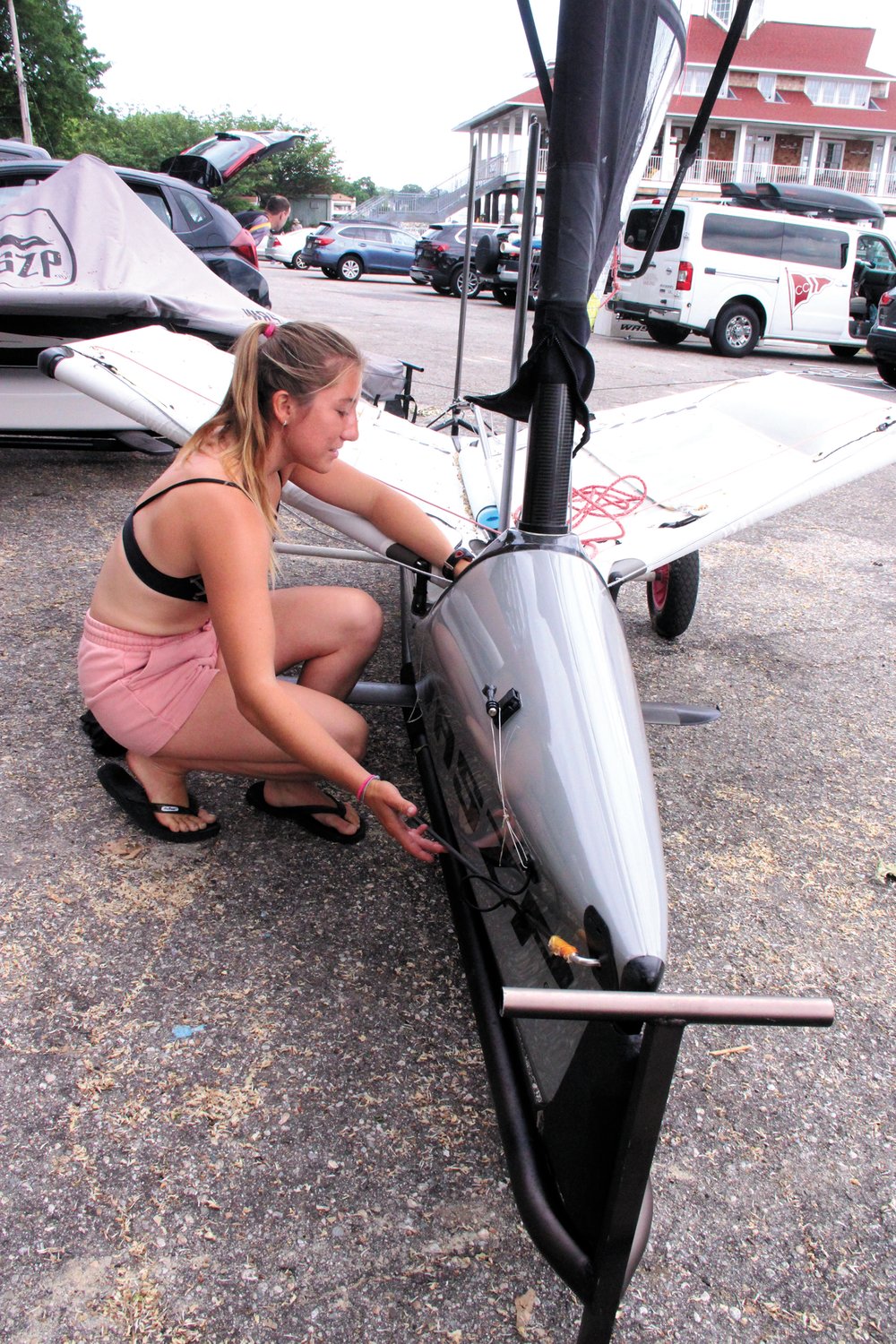 NOT MUCH TO IT: Pearl Lattanzi points out one of the features of a WASZP, called a wand, which adjusts the foils similar to the flaps on an airplane.  
(Beacon Communications photos)