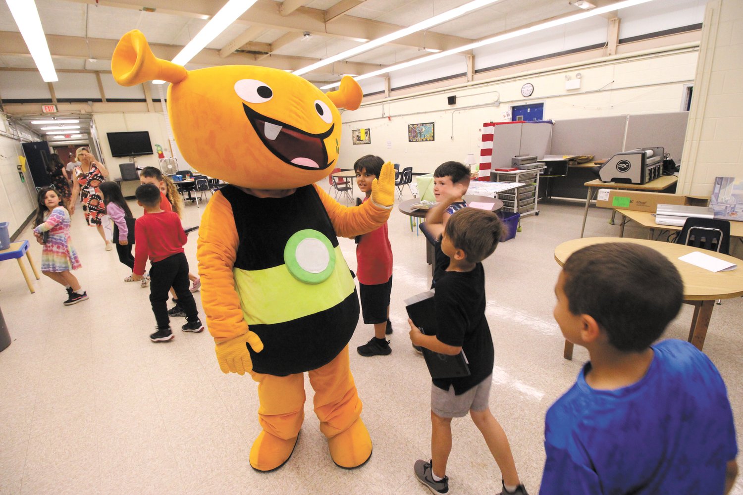 THEY LOVE HER: Plory gives high-fives to Park Elementary students. The character from iReady math programs visited all Warwick elementary schools at the end of the academic year to recognize their dramatic improvement in math proficiency. (Warwick Beacon photos)
