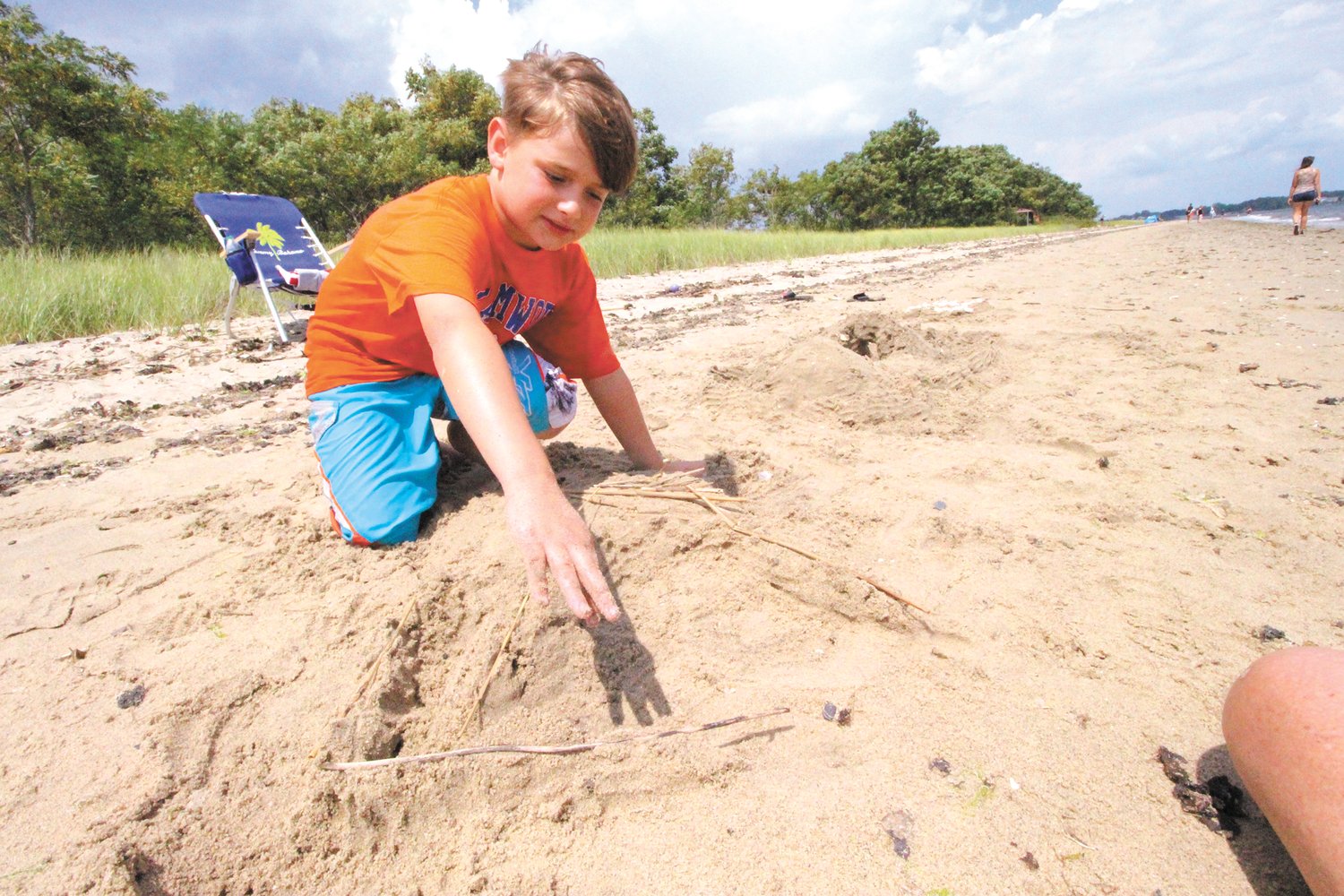HIS OWN GASPEE: As divers looked to traces of the Gaspee off Gaspee Point, Bryce Sorrentino sculpted a ship out of sand with sticks as broken spars.