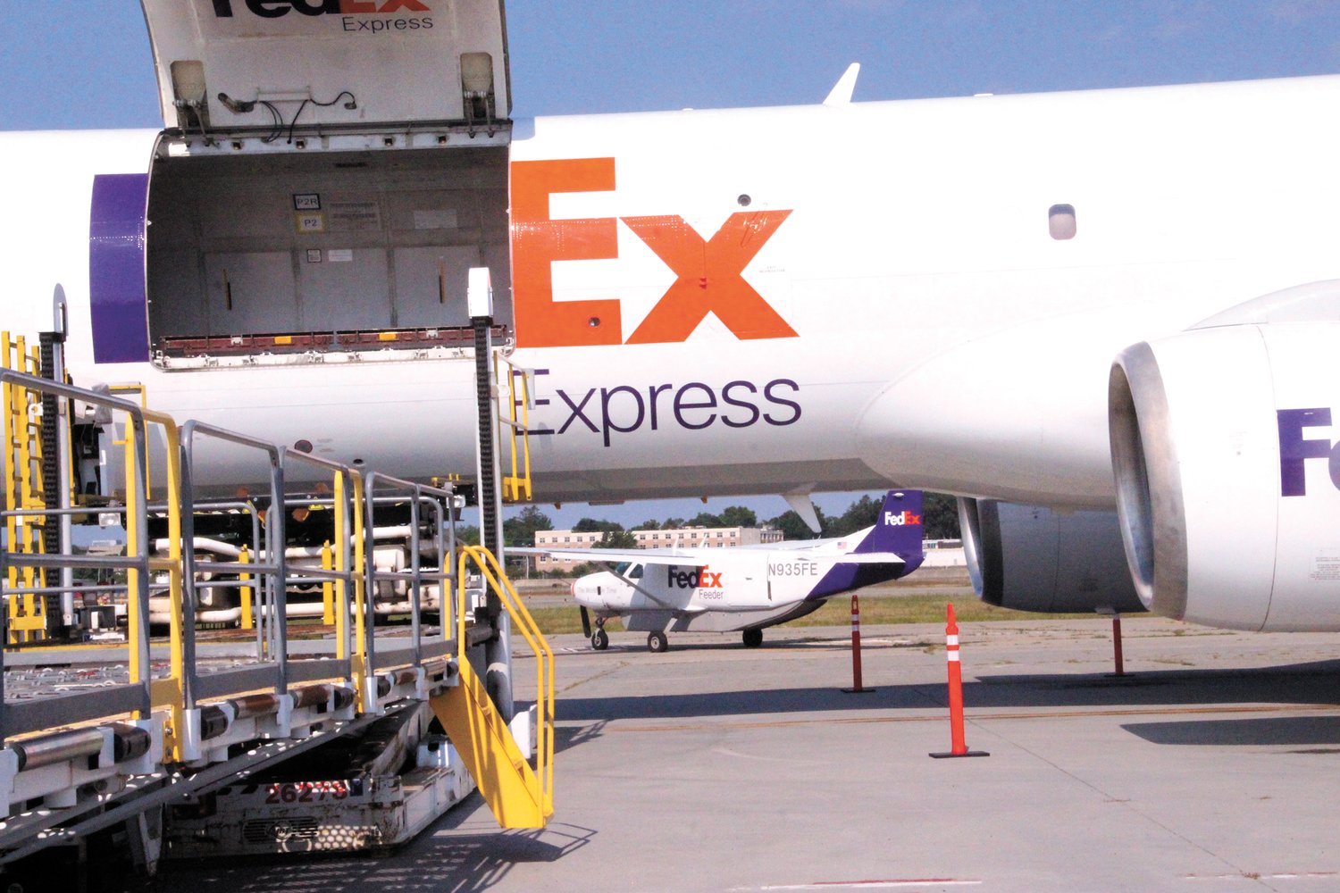 BIG BROTHER LITTLE SISTER: A FedEx 757 dwarfs a smaller plane from the FedEx fleet on its way to make a delivery. (Cranston Herald photos)