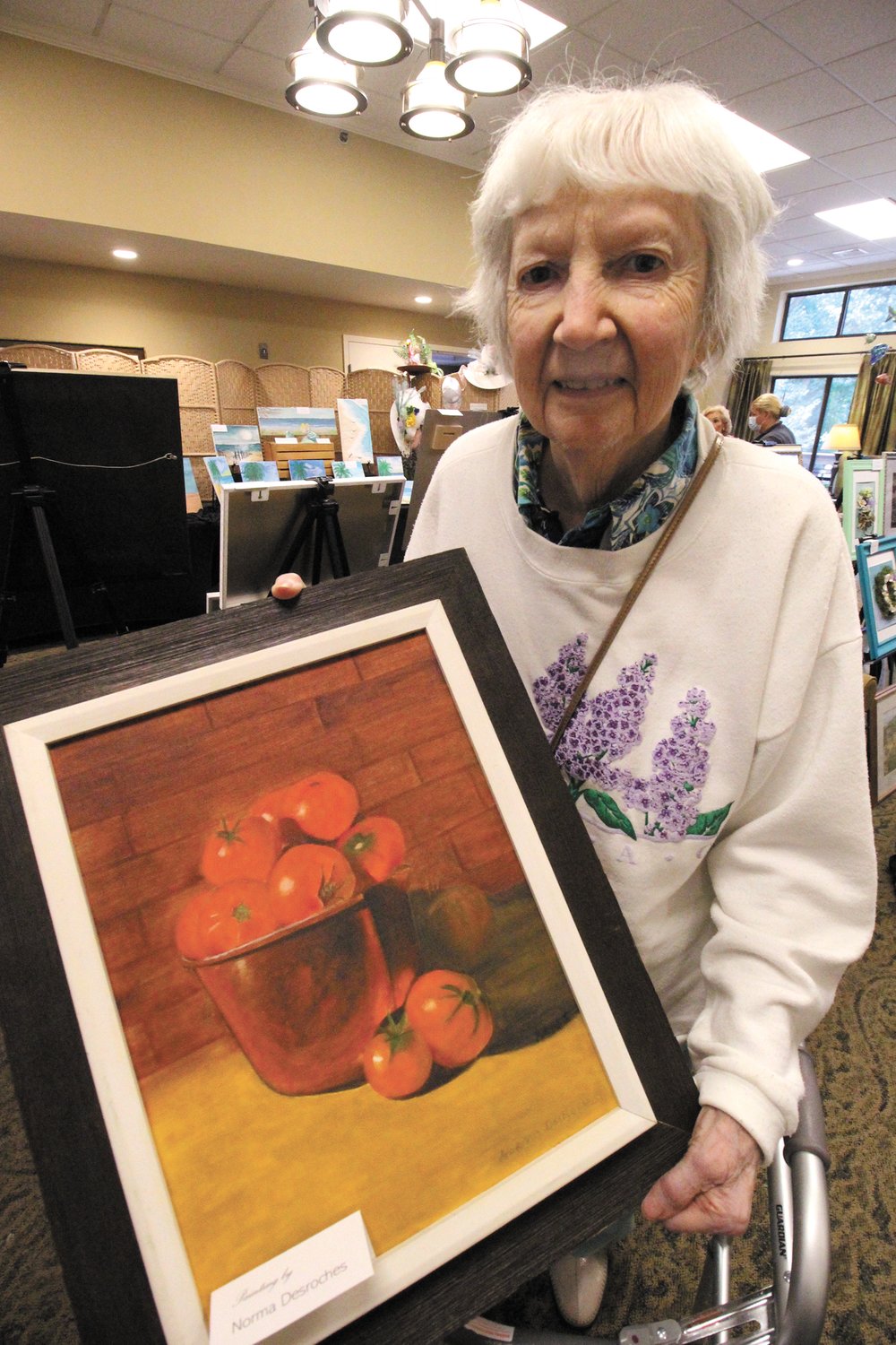 IN SEASON: Resident Norma DesRoches displays her painting of ripe tomatoes.