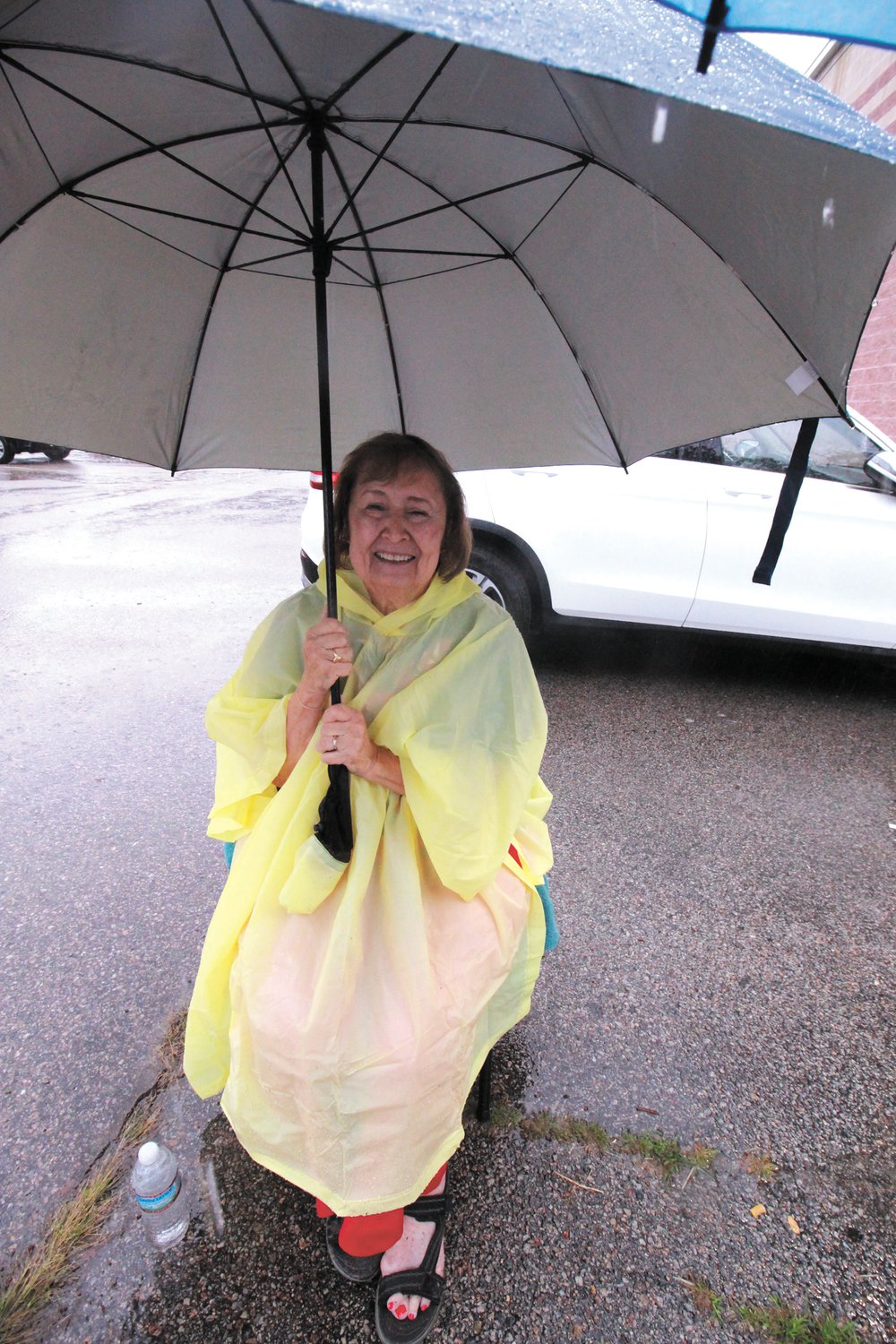 WRAPPED UP: Cindy Cook, wife of Ward 1 candidate Barry Cook was ready for the rain outside the former John Brown Francis School poll.