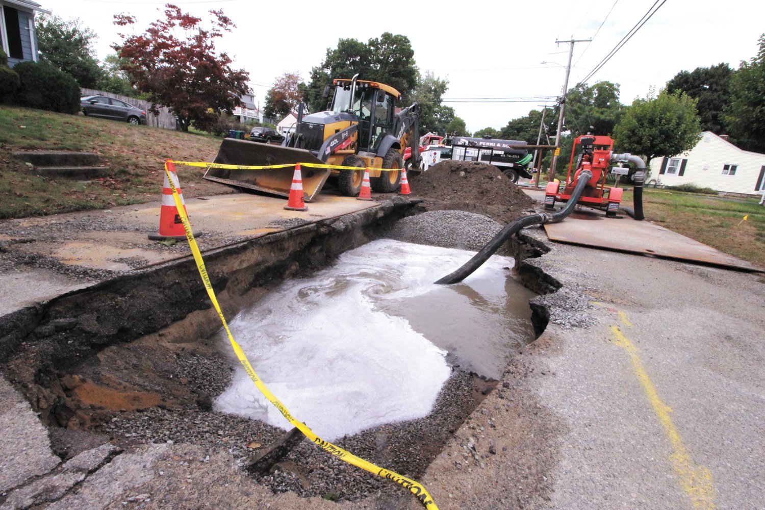 TRYING TO CATCH IT: As wastewater flowed from the ruptured forced main sewer line in Lake Shore Drive, it was pumped into a catch basin and then into septic tank trucks. However, not all of the waste water was captured leaving it to flow into Warwick Pond. (Warwick Beacon photos)