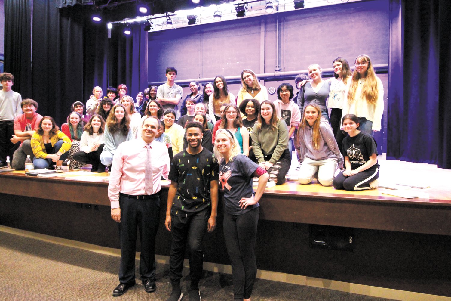 MENTORS AND STUDENTS: Broadway performer Michael Harmon is flanked by those who instructed him while a student in Pilgrim, Richard Denningham and Jenna Tremblay Reilly as the cast of the Pilgrim Players production of Rock of Ages gather on stage.
