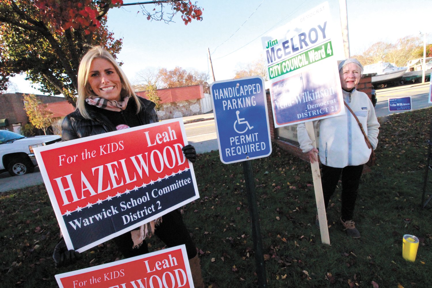 GREETING VOTERS: Rachel Hazelwood, daughter of  District 2 School Committee candidate Leah Hazelwood and Ann Gooding, who is supporting Democratic candidate Camille Vella-Wilkinson for reelection welcomed the morning sun outside the William Shields Post in Conimicut.