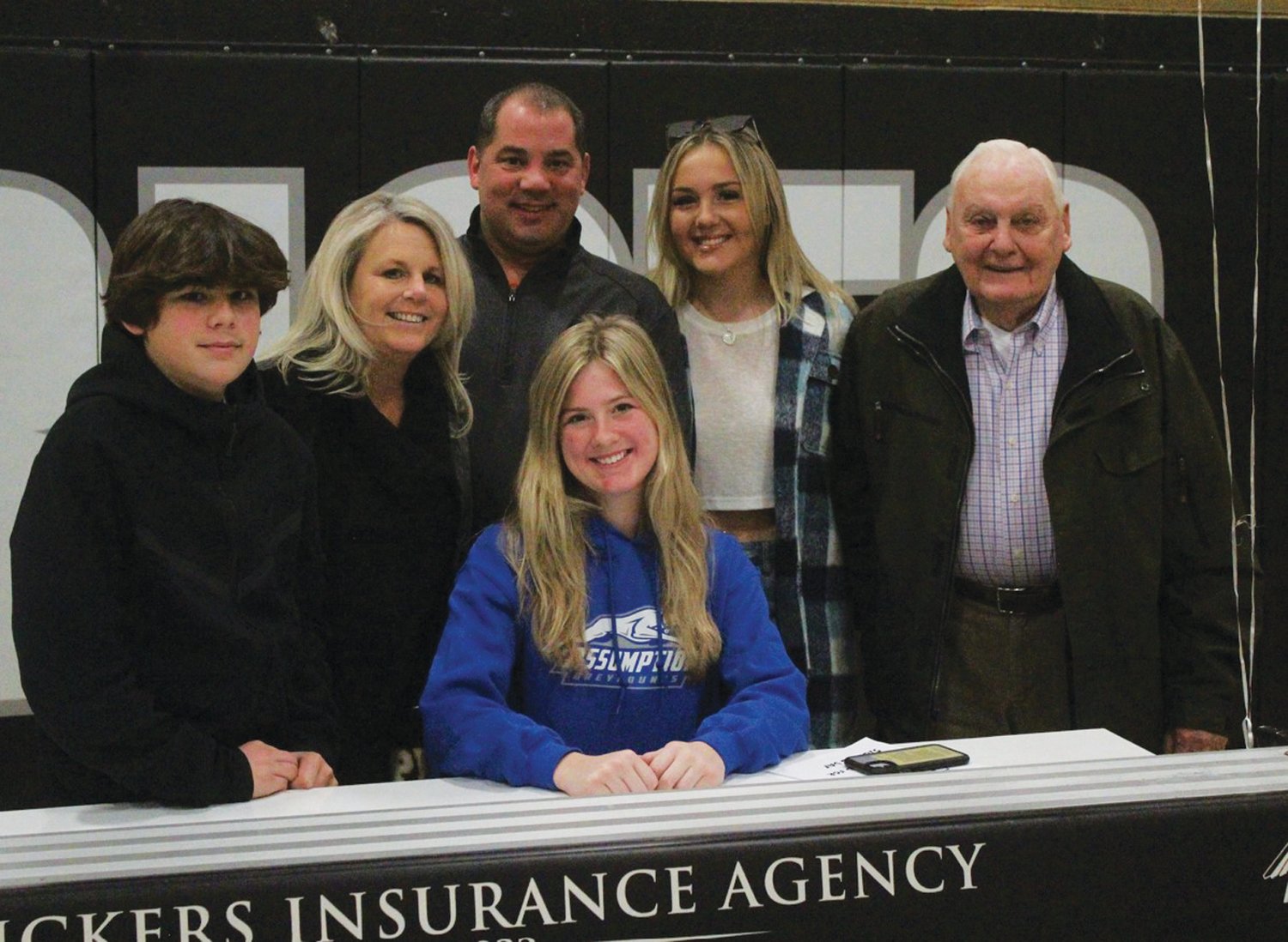 FUTURE GREYHOUND: Gillian Brown signs her NLI alongside her family last week. (Photos by Alex Sponseller)