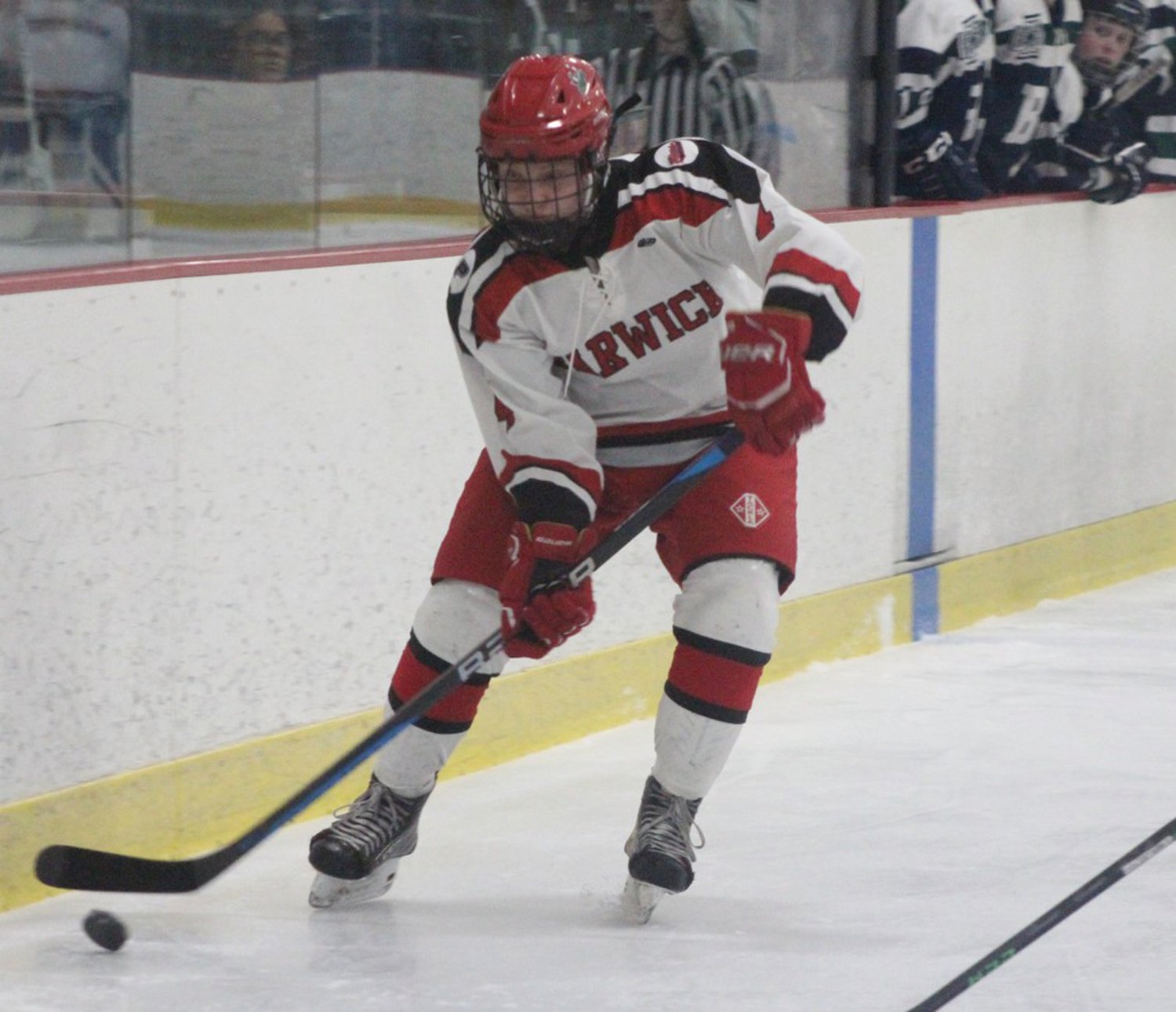 ALONG THE BOARDS: Mia Campbell works the puck up the ice.
