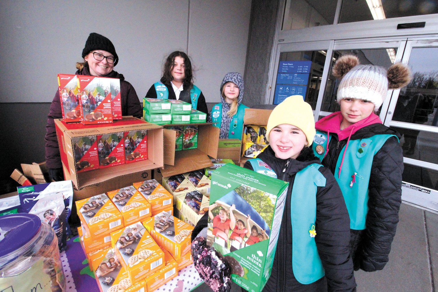 Rhode Island Mall Walmarrt  shoppers found it difficult to resist the treats as they left the store Saturday morning. Girl Scout Troop 79 Warwick had an expansive display of cookies to choose from. Sales enable the girls to go on camping trips and provide for enrichment activities.  Cookies are $5 a box. Pictured from left with troop leader Bobbie J. Gemma are Olivia Froman, Jocelyn Anderson,  and in foreground Aundrea Gemma and Paige Murphy. Thin mints, as displayed here, continue to be a favorite. (Warwick Beacon photo)