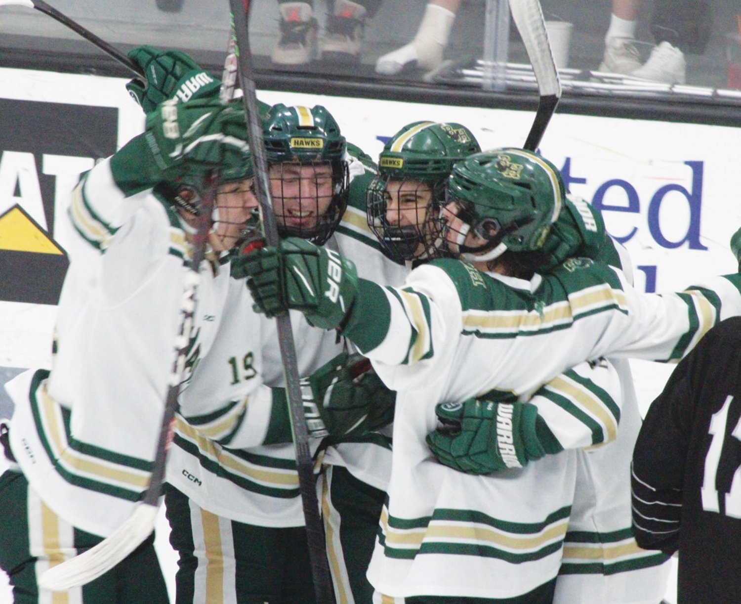 ON TO THE FINALS: Members of the Hendricken hockey team after scoring a goal. (Photos by Alex Sponseller)
