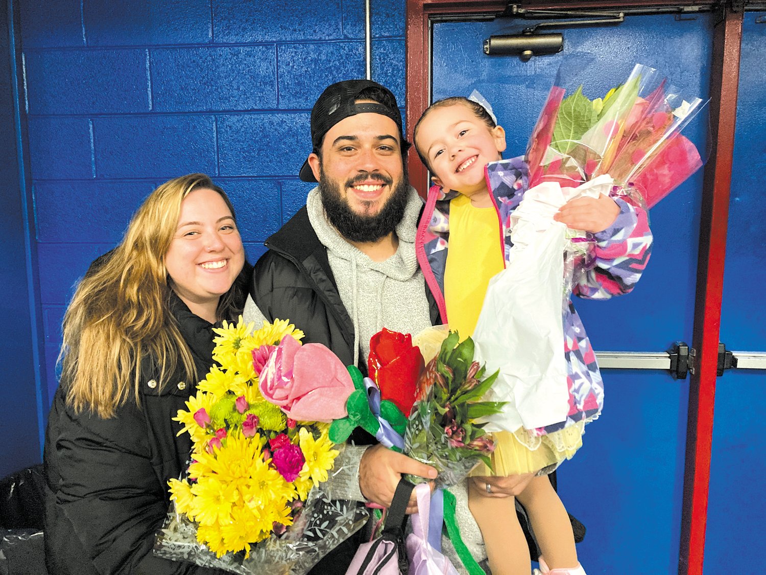 BEAUTIFUL BOUQUET: Four year old Kiara Conway is showered with flowers for her group performance Cover Me in Sunshine. Here she happily poses with her mom,Courtney, and dad Geoff. This was her first year skating and her mom says she loves it. They live in Warwick and Kiara is in preschool at St. Peter’s.