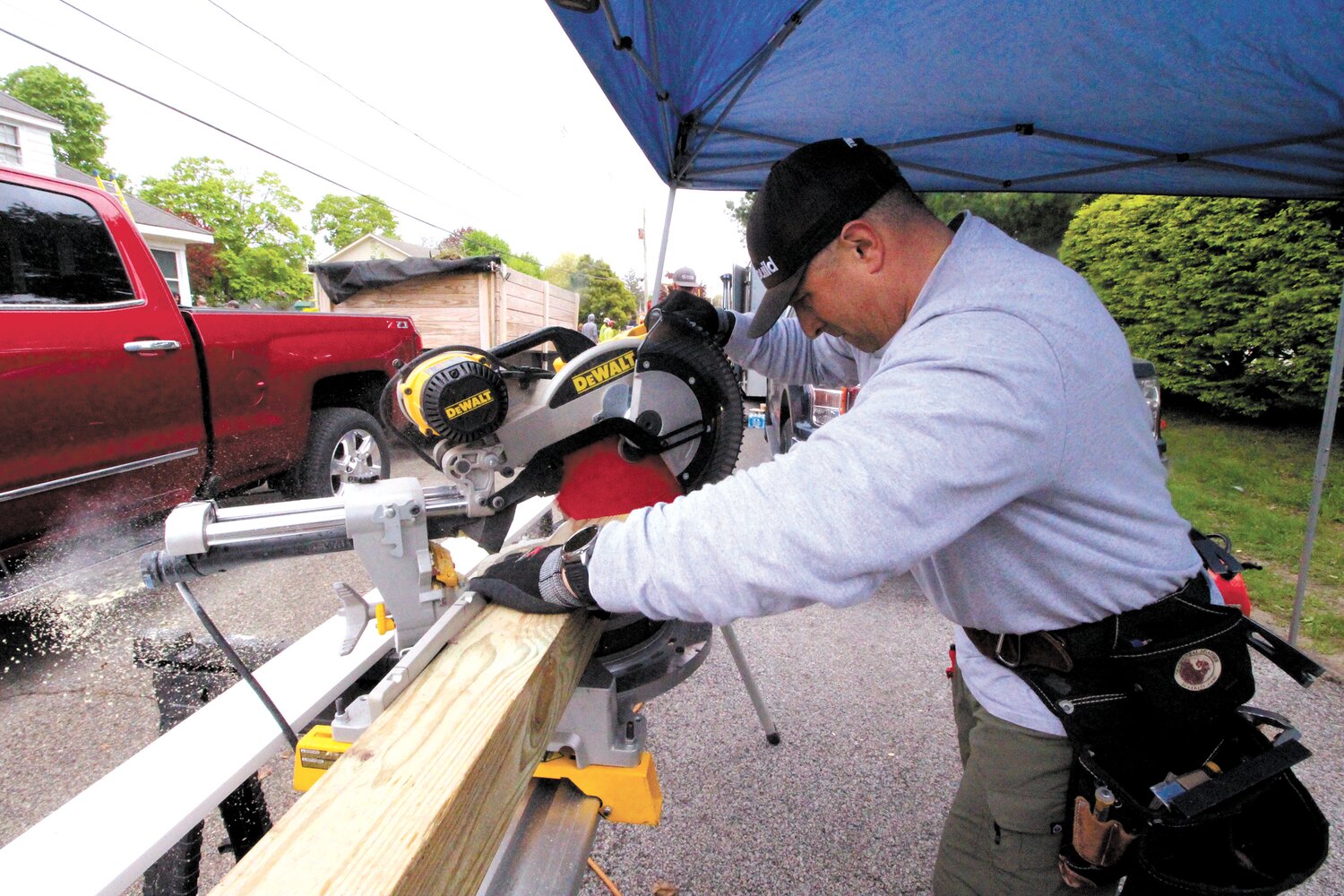 THE RIGHT TOOLS: Chris Sullivan, owner of Hilton Home Improvement brought his truck and a tent to set up an onsite shop to make repairs.