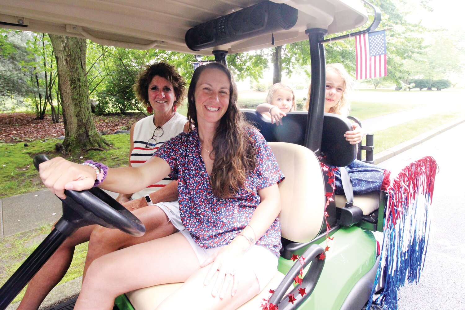 Joan Allen decked out her golf cart so that she, her daughter Nicole Demir and her daughters Lianna and Theodora could ride in patriotic style in the Warwick Neck Fourth of July parade. Unfortunately, or maybe it was a good thing since it poured, the parade was canceled. When the sun peeked out by mid morning, the girls couldn’t resist riding the streets of Anglesea.
