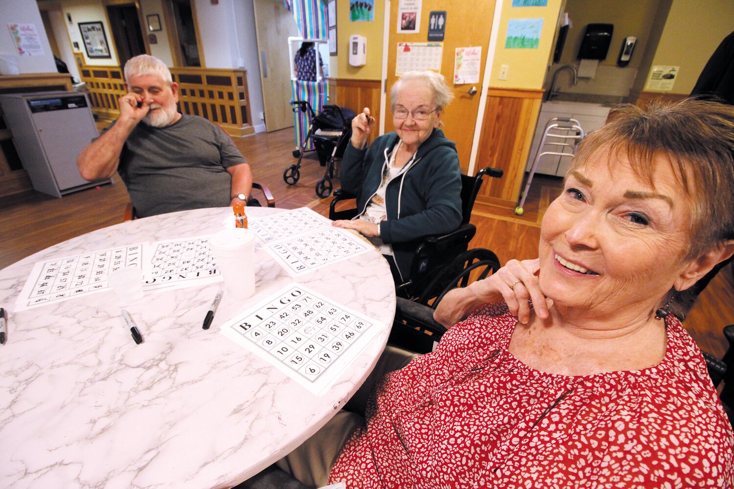 WINNING IS ALWAYS GOOD: Allan Gourse, Diana Ware and Bonnie Norberg wore smiles following an afternoon of bingo at Warwick Health Care Center even though none were winners. The center has daily activities to engage residents. (Warwick Beacon photos)