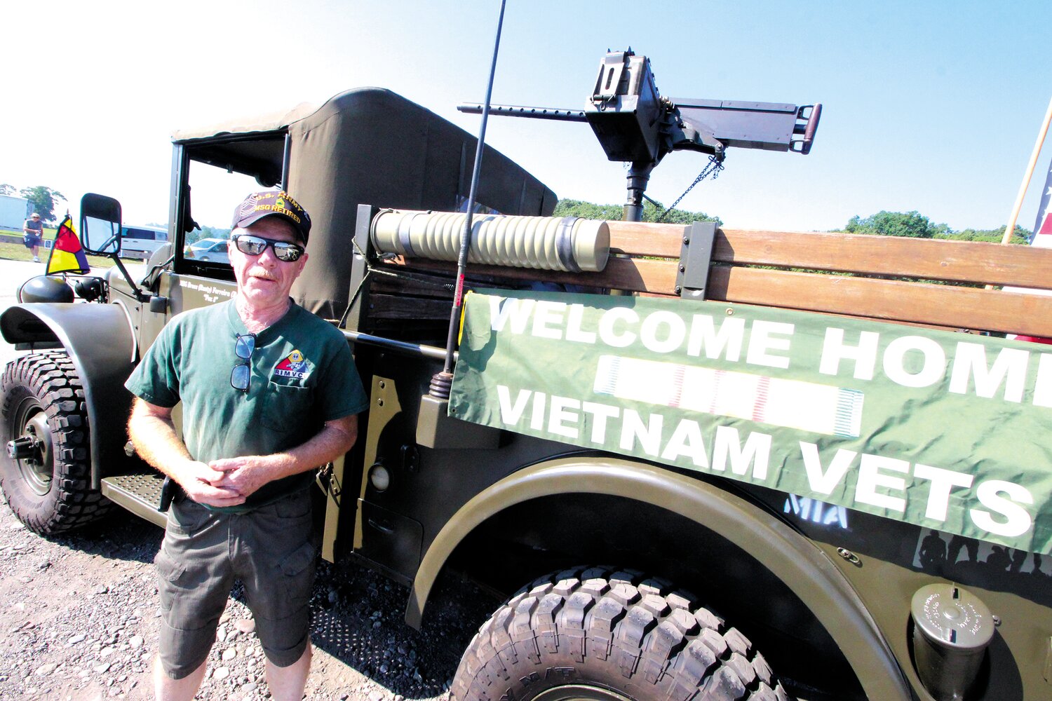 RIDING IN STYLE: Pascoag’s Bruce Ferreira, an Army veteran and the chairman of the Rhode Island Military Vehicles Collector’s Club, stands with his Dodge M37 “Emma,” which he named after his mom. The MVCC provided an escort as the wall arrived at Rocky Point Thursday morning.