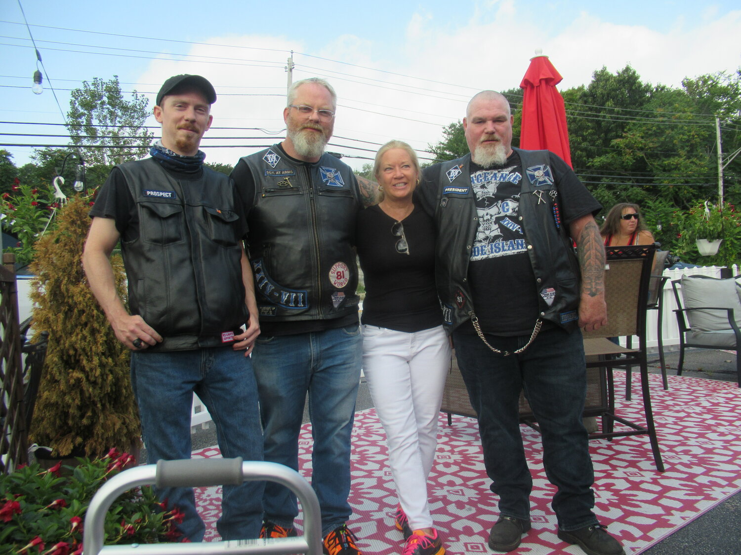 GRAND GIVERS: Michele Brannigan, Senior Philanthropic Officer/Campaign Manager at Hasbro Children’s Hospital, is all smiles while standing with the Smiths – Guy, Byron and Mark – of the Vengeance Motorcycle Club for the recent 7th annual run.
